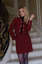 a lady in a red tweed sequins jacket and a skirt